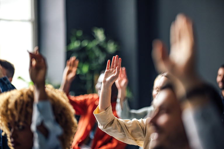 Hands raised at an event.