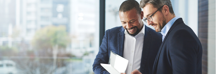 Two men looking at at a document.