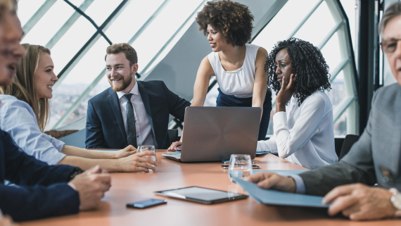 Photo of a group of people working together around a table