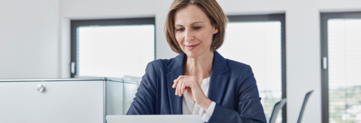 Advisor focusing on a document on her laptop