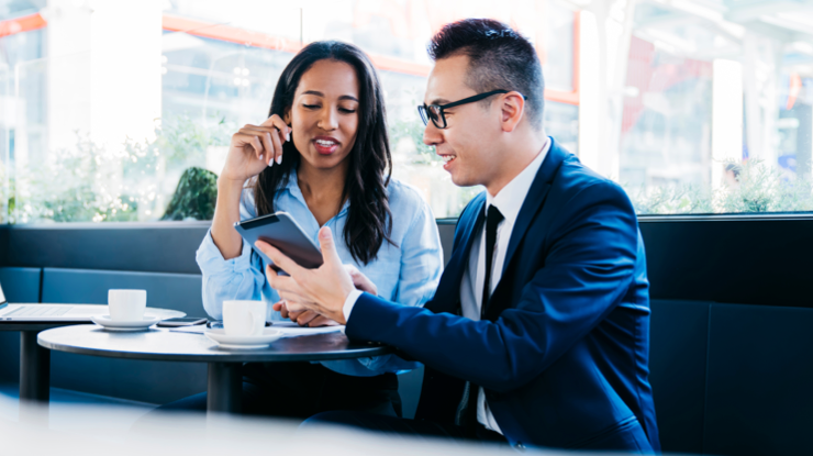 Advisor showing a client information on a smartphone