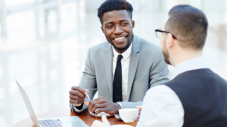 Young advisor talking to a client at a table